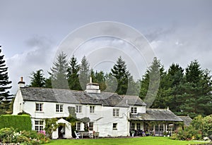 English white cottage in woodland