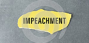 English word impeachment written on a torn