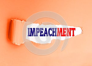 English word impeachment written on a torn paper