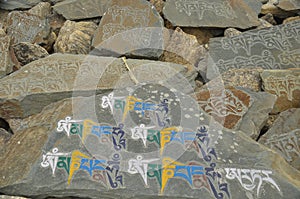 Engraved stones with Buddhist mantra Om Mani Padme Hum in Ladakh, INDIA