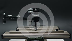 Engraving device pantograph rotating on black background