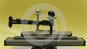 Engraving device pantograph rotating on yellow background