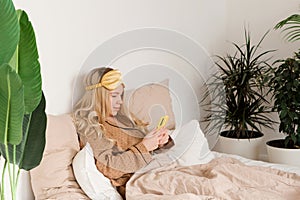 Engrossed in smartphone in morning bed