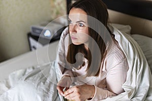 Engrossed Woman Watching Movie with Projector at Home