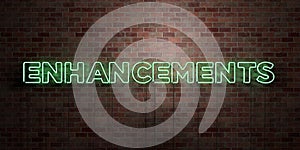 ENHANCEMENTS - fluorescent Neon tube Sign on brickwork - Front view - 3D rendered royalty free stock picture