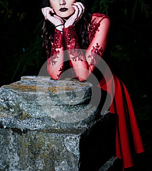 Enigmatic Gothic Beauty - Slender Woman in Red Dress Amidst Dark Forest