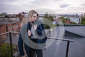 Enigmatic young woman wearing in man`s jacket