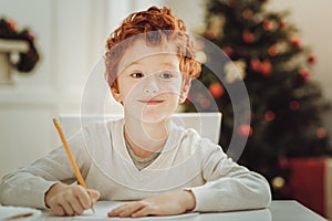 Enigmatical red haired boy creating plan photo