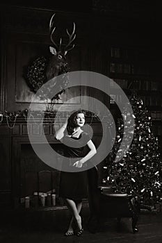 Enigmatical woman in home interior in bw