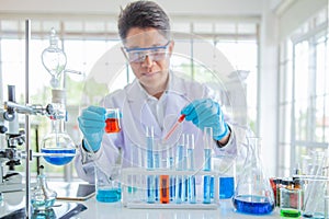 Enior male researcher carrying out scientific research in a lab