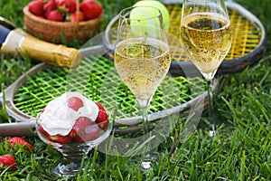 Enjoing in Wimbledon tennis championship with champagne and strawberries with cream