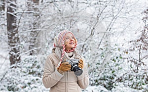 Enjoy beauty of snow scenery through photos. Woman photographer with professional camera. Enjoy enchanting paleness and