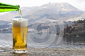 Enjoy beer with mountain landscape beside Lake Ashi Hakone, Japan.