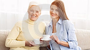 Enjoy breakfast with mom. Mother and daughter holding cups