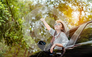 Enjoy Car travel of woman driving with sunglasses journey at nature forest