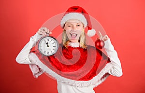 Enjoy celebration happy new year. Girl happy wear santa costume celebrate christmas hold ball decor red background