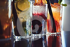 Enjoy a drink. Iced drinks in cocktail glasses in bar. Alcoholic mixed drinks with ice. Juicy beverages with alcohol on