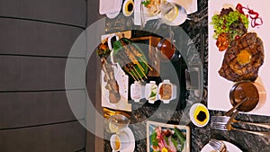 Enjoy fine food dining in luxury restaurant with table full of food