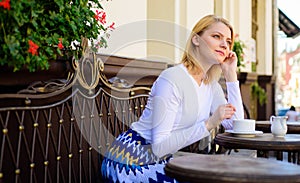 Enjoy her life. Woman blonde dreamy smiling face enjoy having coffee, urban background defocused. What do girls dream