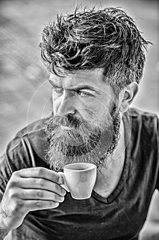 Enjoy hot drink. Hipster drinking fresh brewed coffee. Man with beard and mustache and espresso cup. Bearded guy consume