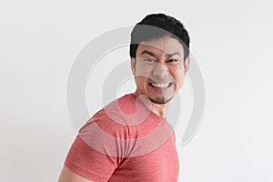 Enjoy and laughing face of man in red t-shirt on isolated background.