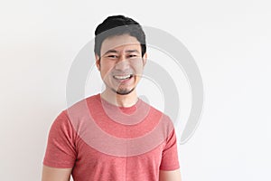 Enjoy and laughing face of man in red t-shirt on isolated background.