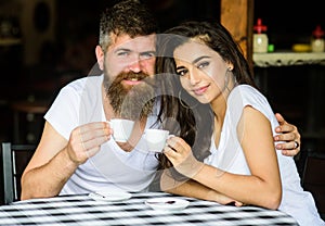 Enjoy moment with cup of coffee drink. Couple in love drink black espresso coffee in cafe. Man with beard and attractive