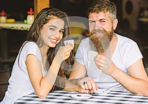 Enjoy moment with cup of coffee drink. Man with beard and attractive happy smiling girl hold hands drinking coffee