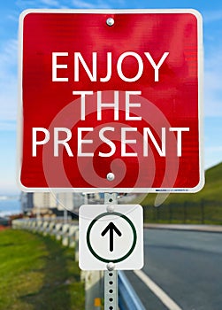 Enjoy the present red sign board