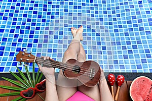 Enjoy summer breeze holiday, Girl relaxing near the swimming pool with watermelon fruit.