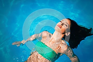 Enjoy the summer. Woman relaxing in the pool water