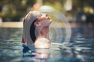 Enjoy the summer. Woman relaxing in the pool water