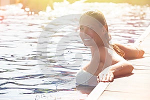 Enjoy the summer. Woman relaxing in the pool water