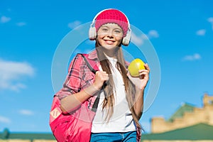 Enjoy the taste of eating right. Happy kid hold apple sunny outdoors. Fruit snack. Healthy eating habits. Vegetarian