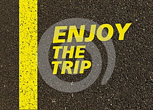 Enjoy the trip written on the road.