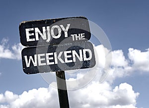Enjoy the Weekend sign with clouds and sky background photo