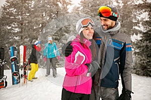 Enjoying in beautiful winter day- couple snowboarder enjoying at