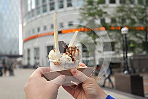 Enjoying a brownie icecream in Canary Wharf , London , UK