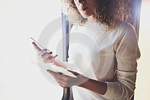 Enjoying business travel concept. Young beautiful brunette tourist girl travelling on the train standing near the window