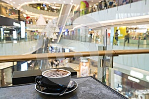 Enjoying coffee in a shopping mall