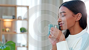 Enjoying a comfortable and cozy tea break. Young woman drinking a hot cup of coffee at home. One beautiful female