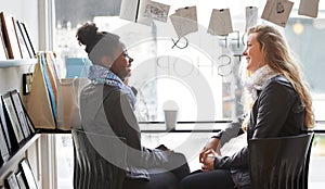 Enjoying a cup of coffee together. Two young women buying coffee together.