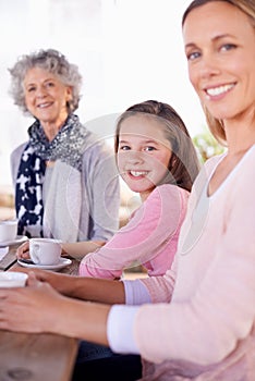 Enjoying a cup of tea and some fresh air. three generations of the woman of the women of a family having tea outside.