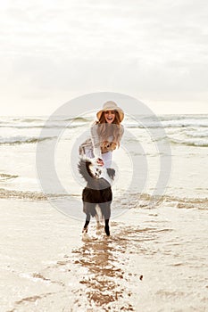 Enjoying a day of play at the beach. a young woman spending some time with her dog at the beach.