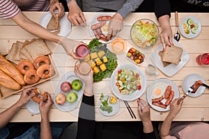 Enjoying dinner with friends. Top view of group of people havin