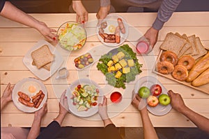 Enjoying dinner with friends. Top view of group of people havin