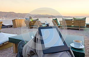 Enjoying an e-book e-reader on the beach