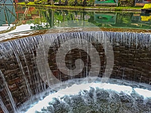 Enjoying the Flowing Beauty: Small Waterfall Inspired by a Dam.