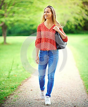 Enjoying the fresh air and beauty of nature. a young woman on a walk through the park.