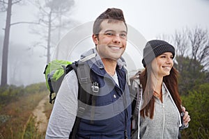 Enjoying the fresh air and the views. a handsome young man on a hike with his girlfriend.